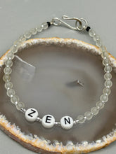 Load image into Gallery viewer, Hand beaded bracelet with clear and silver glass beads, Zen letters Metal wire with hook-eye clasp.