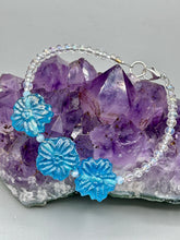 Load image into Gallery viewer, This light blue pressed glass floral bracelet is a sophisticated addition to any summer look. Its iridescent shimmer finish adds a classy touch to its intricate metal wire and lobster claw clasp. Perfect for any nature-inspired wardrobe. Measurements: Bracelet: 8" in length