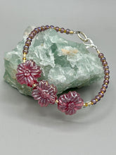 Load image into Gallery viewer, This light purple-pink pressed glass floral beaded bracelet offers delightful detailing with its iridescent shimmer finish. Constructed with metal wire and a lobster claw clasp for secure closure. Measurements: Bracelet: 8" in length