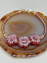 Load image into Gallery viewer, This light purple-pink pressed glass floral beaded bracelet offers delightful detailing with its iridescent shimmer finish. Constructed with metal wire and a lobster claw clasp for secure closure. Measurements: Bracelet: 8" in length