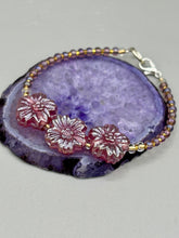 Load image into Gallery viewer, This light purple-pink pressed glass floral beaded bracelet offers delightful detailing with its iridescent shimmer finish. Constructed with metal wire and a lobster claw clasp for secure closure. Measurements: Bracelet: 8" in length