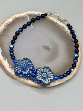 Load image into Gallery viewer, This Dark Blue Violet Pressed Glass Floral Beaded Bracelet features exquisitely detailed components with an iridescent shimmer finish. The piece is crafted with metal wire and a lobster claw clasp.  Measurements:  Bracelet: 8" in length