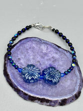 Load image into Gallery viewer, This Dark Blue Violet Pressed Glass Floral Beaded Bracelet features exquisitely detailed components with an iridescent shimmer finish. The piece is crafted with metal wire and a lobster claw clasp.  Measurements:  Bracelet: 8" in length