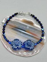 Load image into Gallery viewer, This Dark Blue Violet Pressed Glass Floral Beaded Bracelet features exquisitely detailed components with an iridescent shimmer finish. The piece is crafted with metal wire and a lobster claw clasp.  Measurements:  Bracelet: 8" in length