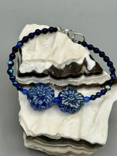 Load image into Gallery viewer, This Dark Blue Violet Pressed Glass Floral Beaded Bracelet features exquisitely detailed components with an iridescent shimmer finish. The piece is crafted with metal wire and a lobster claw clasp.  Measurements:  Bracelet: 8" in length
