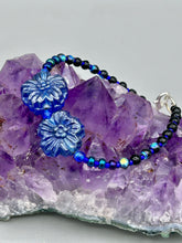 Load image into Gallery viewer, This Dark Blue Violet Pressed Glass Floral Beaded Bracelet features exquisitely detailed components with an iridescent shimmer finish. The piece is crafted with metal wire and a lobster claw clasp.  Measurements:  Bracelet: 8" in length