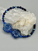 Load image into Gallery viewer, This Dark Blue Violet Pressed Glass Floral Beaded Bracelet features exquisitely detailed components with an iridescent shimmer finish. The piece is crafted with metal wire and a lobster claw clasp.  Measurements:  Bracelet: 8" in length