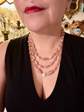 Load image into Gallery viewer, This three-strand beaded necklace is crafted with iridescent dusty rose glass, along with white, gold, pink, and iridescent purple beads for an eclectic mix of colors, tones, and textures. Perfect for any occasion, this gorgeous statement piece will add the finishing touch to your look. Measurements: Necklace is 17” in length, can be adjusted up to 19"