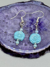 Load image into Gallery viewer, These light blue pressed glass floral beaded earrings feature a fish hook-style closure for a secure fit. Earrings: 1 1/4" length