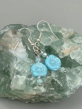 Load image into Gallery viewer, These light blue pressed glass floral beaded earrings feature a fish hook-style closure for a secure fit. Earrings: 1 1/4" length