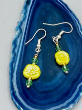 Load image into Gallery viewer, This delicate jewelry displays an array of gentle hues, vibrant yet soft.This light yellow pressed glass floral beaded bracelet and earrings set features an iridescent shimmer finish and is crafted with metal wire and a lobster claw clasp for easy closure. Measurements: Bracelet: 8 1/2" in length Earrings: 1 1/4" length