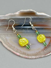 Load image into Gallery viewer, This delicate jewelry displays an array of gentle hues, vibrant yet soft.This light yellow pressed glass floral beaded bracelet and earrings set features an iridescent shimmer finish and is crafted with metal wire and a lobster claw clasp for easy closure. Measurements: Bracelet: 8 1/2" in length Earrings: 1 1/4" length