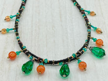 Load image into Gallery viewer, This necklace is the perfect addition to any collection, boasting a dark, elegant aesthetic inspired by nature. Comprised of two strands of glass beads with a variety of shapes and colors, it offers subtle autumnal vibrancy with its orange and green pumpkin-shaped glass beads. This piece is full of shimmer and complexity, providing unique depth and flair. Necklace is 16 1/2” in length, can be adjusted up to 18 1/2"