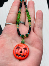 Load image into Gallery viewer, All Hallows Eve Pumpkin Necklace, Dark Souls Goth Necklace, Trick Or Treat, Halloween Spirit Costume Jewelry, Jack O Lantern PendantThis 25mm bright orange pumpkin bead pendant necklace is a perfect complement to any Halloween ensemble. It is additionally enhanced by shimmery glass beads in classic Halloween hues, such as black, dark green, and light green. Measurements: Necklace is 19”