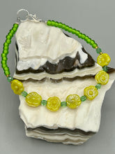 Load image into Gallery viewer, This delicate jewelry displays an array of gentle hues, vibrant yet soft.This light yellow pressed glass floral beaded bracelet and earrings set features an iridescent shimmer finish and is crafted with metal wire and a lobster claw clasp for easy closure. Measurements: Bracelet: 8 1/2" in length Earrings: 1 1/4" length