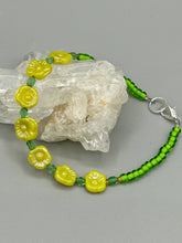 Load image into Gallery viewer, This delicate jewelry displays an array of gentle hues, vibrant yet soft.This light yellow pressed glass floral beaded bracelet and earrings set features an iridescent shimmer finish and is crafted with metal wire and a lobster claw clasp for easy closure. Measurements: Bracelet: 8 1/2" in length Earrings: 1 1/4" length
