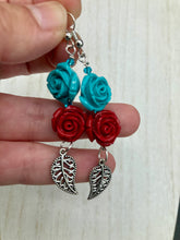 Load image into Gallery viewer, This alluring set of earrings captures the vibrant, enchanting beauty of the desert, featuring blue turquoise and bright red accents, highly detailed quartize rose beads and intricate silver plated leaf, providing fun movement. Perfect for those who love the Southwestern feel, Dia De Los Muertos, they can be dressed up or down, giving your fashion a unique touch. Measurements: 2” in length