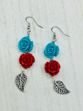 Load image into Gallery viewer, This alluring set of earrings captures the vibrant, enchanting beauty of the desert, featuring blue turquoise and bright red accents, highly detailed quartize rose beads and intricate silver plated leaf, providing fun movement. Perfect for those who love the Southwestern feel, Dia De Los Muertos, they can be dressed up or down, giving your fashion a unique touch. Measurements: 2” in length
