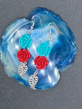Load image into Gallery viewer, This alluring set of earrings captures the vibrant, enchanting beauty of the desert, featuring blue turquoise and bright red accents, highly detailed quartize rose beads and intricate silver plated leaf, providing fun movement. Perfect for those who love the Southwestern feel, Dia De Los Muertos, they can be dressed up or down, giving your fashion a unique touch. Measurements: 2” in length