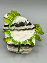 Load image into Gallery viewer, This nature-inspired jewelry is crafted from shimmering glass beads in shades of light and dark green as well as clear iridescent and gold tones. Light and dark green glass leaf beaded anklet and earrings provide intricate detailing. Crafted with metal wire and a barrel screw clasp, they offer a secure fit.