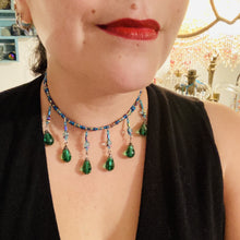 Load image into Gallery viewer, This Victorian-style necklace features a combination of green and blue glass beads, and rectangular, rainbow hematite beads for a layered and textured effect. The dramatic dark-green glass tear drops dangling from the strands provide additional depth and sophistication. Double-hole flat matte blue beads are used to hold the two strands together, creating a collar-like shape that softly cascades over your neckline. It is a striking, bold and elegant accessory.