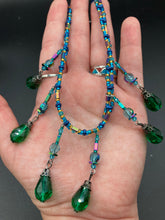 Load image into Gallery viewer, This Victorian-style necklace features a combination of green and blue glass beads, and rectangular, rainbow hematite beads for a layered and textured effect. The dramatic dark-green glass tear drops dangling from the strands provide additional depth and sophistication. Double-hole flat matte blue beads are used to hold the two strands together, creating a collar-like shape that softly cascades over your neckline. It is a striking, bold and elegant accessory.
