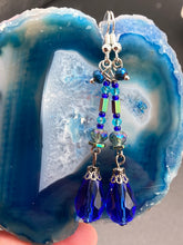 Load image into Gallery viewer, This beautifully and bold set of glass beaded earrings were inspired by the vibrant and beautiful colors of the galaxy and the cosmos full of colors that makes a stunning statement piece of jewelry. Rectangular rainbow Hematite beads add a different texture to the style. This is a bold piece of jewelry, a “must have”to your collection. Measurements: 2” in length