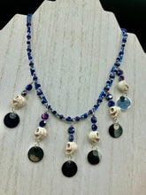 Load image into Gallery viewer, Stunning Cascade of Edgy Gun Metal Shimmery Glass Bead Necklace. Contains six dangling strands of beautiful and bold skulls and glass beads. A variety of shapes and different color glass beads are used that contain hues of silver, purple, pink, blue, and gold tones. This bold and beautiful necklace comes with dainty matching earrings to complete the look. Measurements: Necklace is 14 1/2” adjustable up to 18" - each glass skulls measures 1 3/4” in Height