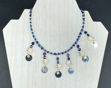 Load image into Gallery viewer, Stunning Cascade of Edgy Gun Metal Shimmery Glass Bead Necklace. Contains six dangling strands of beautiful and bold skulls and glass beads. A variety of shapes and different color glass beads are used that contain hues of silver, purple, pink, blue, and gold tones. This bold and beautiful necklace comes with dainty matching earrings to complete the look. Measurements: Necklace is 14 1/2” adjustable up to 18" - each glass skulls measures 1 3/4” in Height