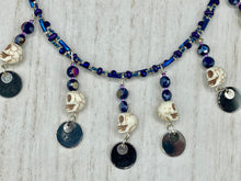 Load image into Gallery viewer, Stunning Cascade of Edgy Gun Metal Shimmery Glass Bead Necklace. Contains six dangling strands of beautiful and bold skulls and glass beads. A variety of shapes and different color glass beads are used that contain hues of silver, purple, pink, blue, and gold tones. This bold and beautiful necklace comes with dainty matching earrings to complete the look. Measurements: Necklace is 14 1/2” adjustable up to 18" - each glass skulls measures 1 3/4” in Height