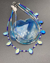 Load image into Gallery viewer, This exquisite Winter Frost Nature Inspired Jewelry has all your style needs covered. A detailed, glass beaded necklace featuring an array of blues, silver and gold tones adorns your neck to add a touch of elegance to any look. Effortlessly dress it up or down to complement any ensemble. Measurements: Necklace is 14” in length, can be adjusted up to 18"