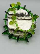 Load image into Gallery viewer, This nature-inspired jewelry is crafted from shimmering glass beads in shades of light and dark green as well as clear iridescent and gold tones. Light and dark green glass leaf beaded anklet and earrings provide intricate detailing. Crafted with metal wire and a barrel screw clasp, they offer a secure fit.