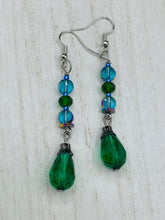 Load image into Gallery viewer, Beautiful and bold set of glass beaded earrings were inspired by the stunning and vibrant peacock feathers, full of color that makes a unique statement piece of jewelry. The primary color is the bright green glass beads that contain hues of blues, purples, and a tint of gold to complement each other and I added a different size and shape beads to create texture to the style. This is a bold piece of jewelry, a “must have” to your collection. Measurements: 2” in length