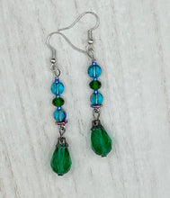 Load image into Gallery viewer, Beautiful and bold set of glass beaded earrings were inspired by the stunning and vibrant peacock feathers, full of color that makes a unique statement piece of jewelry. The primary color is the bright green glass beads that contain hues of blues, purples, and a tint of gold to complement each other and I added a different size and shape beads to create texture to the style. This is a bold piece of jewelry, a “must have” to your collection. Measurements: 2” in length