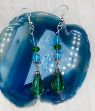 Load image into Gallery viewer, Beautiful and bold set of glass beaded earrings were inspired by the stunning and vibrant peacock feathers, full of color that makes a unique statement piece of jewelry. The primary color is the bright green glass beads that contain hues of blues, purples, and a tint of gold to complement each other and I added a different size and shape beads to create texture to the style. This is a bold piece of jewelry, a “must have” to your collection. Measurements: 2” in length