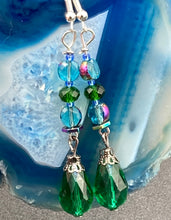 Load image into Gallery viewer, Beautiful and bold set of glass beaded earrings were inspired by the stunning and vibrant peacock feathers, full of color that makes a unique statement piece of jewelry. The primary color is the bright green glass beads that contain hues of blues, purples, and a tint of gold to complement each other and I added a different size and shape beads to create texture to the style. This is a bold piece of jewelry, a “must have” to your collection. Measurements: 2” in length