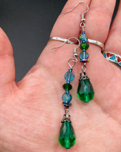 Load image into Gallery viewer, Beautiful and bold set of glass beaded earrings were inspired by the stunning and vibrant peacock feathers, full of color that makes a unique statement piece of jewelry. The primary color is the bright green glass beads that contain hues of blues, purples, and a tint of gold to complement each other and I added a different size and shape beads to create texture to the style. This is a bold piece of jewelry, a “must have” to your collection. Measurements: 2” in length