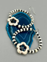 Load image into Gallery viewer, These handcrafted bohemian earrings combine an eye-catching white magnesite flower bead with a tiny hematite star bead, all charmingly displayed in a bone and glass beaded hoop. Perfect for adding a touch of hippie, shabby chic or boho chic vibes to your style. Measurements: 2" length