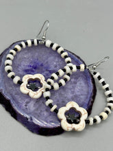 Load image into Gallery viewer, These handcrafted bohemian earrings combine an eye-catching white magnesite flower bead with a tiny hematite star bead, all charmingly displayed in a bone and glass beaded hoop. Perfect for adding a touch of hippie, shabby chic or boho chic vibes to your style. Measurements: 2" length