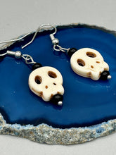 Load image into Gallery viewer, These stylish skull earrings are perfect for adding a unique flair to any outfit. Whether you're looking for a Dia De Los Muertos accessory or simply looking to draw inspiration, these goth pieces perfectly capture the vampire goth, witchy, dark, Chingona Cabrona, Latina Chicana styles.  Measurements: 1 1/4 ” in length