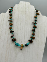 Load image into Gallery viewer, This bold earthy tone necklace presents an eye-catching combination of natural tigers eye stone chips and blue-green turquoise glass beads, making it an ideal statement piece. Measurements: Necklace is 18 3/4 " in length adjustable to 20"