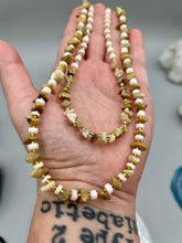 Load image into Gallery viewer, This natural bamboo, bone, and gold glass beaded necklace is the perfect piece to add versatility to any outfit. The neutral colors blend easily with any look and will give your outfit an unforgettable look. Measurements: Necklace: 15" - can be adjusted up to 16"