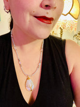 Load image into Gallery viewer, This opalite stone pendant with its shimmering hues of blue, gold, and pink is inspired by the whimsical beauty of nature. I created a beaded necklace using iridescent glass beads with the same colors of blue, gold, and pink to enhance the look of the Vibrant Tree Of Life Opalite Wired Stone Pendant. Measurements: Necklace is 20”