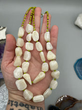 Load image into Gallery viewer, This exquisite necklace features large natural Calcite beads complemented by Wasabi Green glass beads. Two strands of neutral colors bring a sophisticated look that can dress up or dress down any outfit for a one-of-a-kind style. Measurements: Necklace is 17 1/4 " in length adjustable to 18 1/2"
