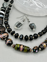 Load image into Gallery viewer, This striking set of earrings features large square-shaped clear glass beads adorned with black-and-white designs. Neutral-hued stone beads lend a cool feel, making them both unique and versatile. Measurements: 1 1/4” in length