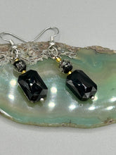 Load image into Gallery viewer, Elegantly crafted from black rectangular and circular glass beads, these dainty earrings offer a versatile style that can effortlessly elevate any ensemble. Measurements: 1 3/8” in length