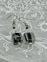 Load image into Gallery viewer, This striking set of earrings features large square-shaped clear glass beads adorned with black-and-white designs. Neutral-hued stone beads lend a cool feel, making them both unique and versatile. Measurements: 1 1/4” in length