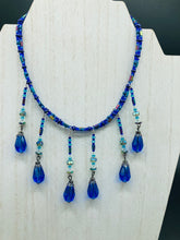 Load image into Gallery viewer, This Victorian Gothic Cobalt Blue Glass Beaded Choker Style Necklace is a true showstopper, with vibrant blue adjustable collar style glass beading and bright dark blue tear drop glass beads. Rainbow hematite beads are added to create a complex and visually-appealing combination of shapes and colors. Necklace is 14” adjustable up to 18" Victorian Goth, Fairy Winter Wonderland