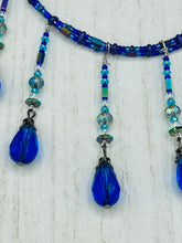 Load image into Gallery viewer, This Victorian Gothic Cobalt Blue Glass Beaded Choker Style Necklace is a true showstopper, with vibrant blue adjustable collar style glass beading and bright dark blue tear drop glass beads. Rainbow hematite beads are added to create a complex and visually-appealing combination of shapes and colors. Necklace is 14” adjustable up to 18" Victorian Goth, Fairy Winter Wonderland