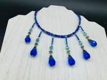 Load image into Gallery viewer, This Victorian Gothic Cobalt Blue Glass Beaded Choker Style Necklace is a true showstopper, with vibrant blue adjustable collar style glass beading and bright dark blue tear drop glass beads. Rainbow hematite beads are added to create a complex and visually-appealing combination of shapes and colors. Necklace is 14” adjustable up to 18" Victorian Goth, Fairy Winter Wonderland